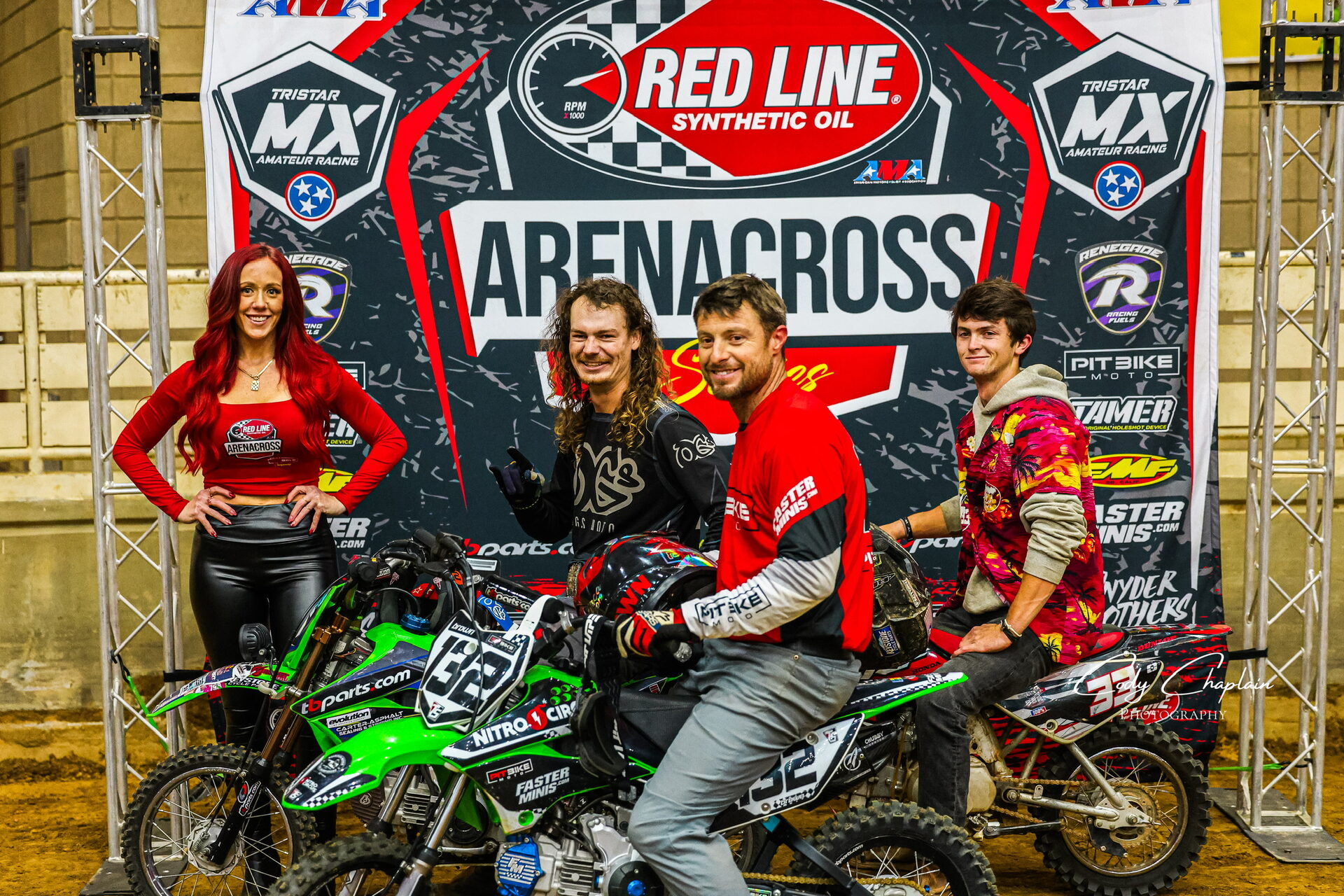 Podium celebration with riders and series banner