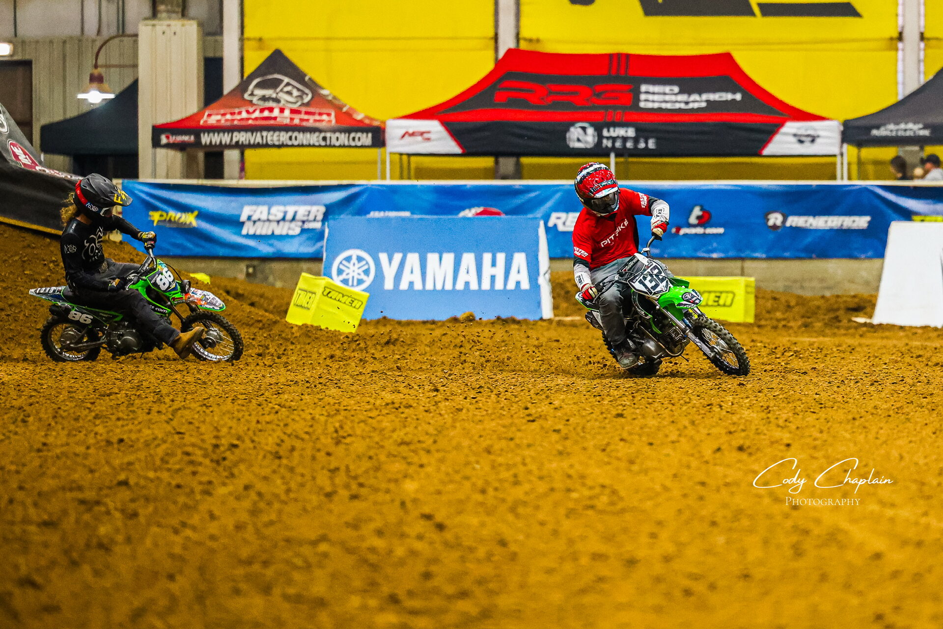 Rider airborne in front of the arena grandstands